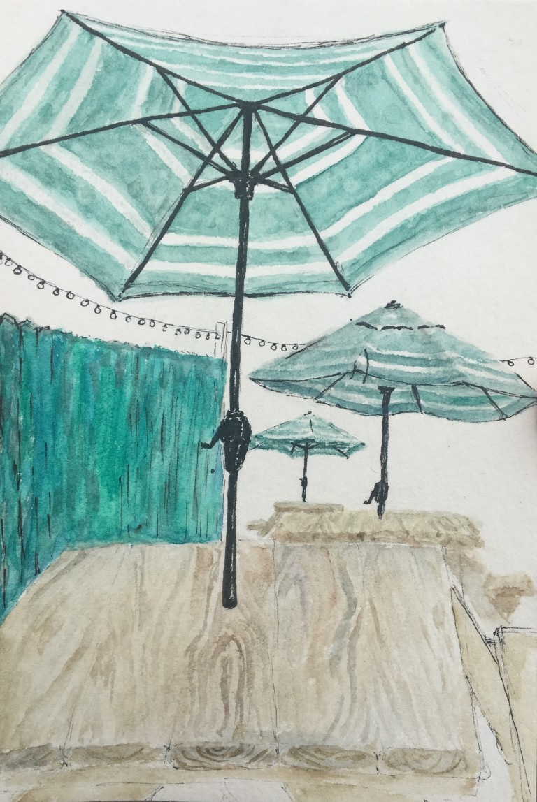 Watercolor and ink of striped teal patio umbrellas beside a wooden building.